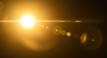 bright golden sun with lens flare effect against dark background. warm light source with bokeh circl