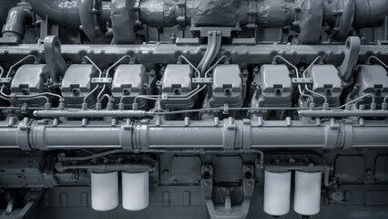Aufkleber - The engine is a massive piece of machinery with many different parts. It is made of gray metal and has a very industrial appearance. The engine is likely used for heavy-duty tasks
