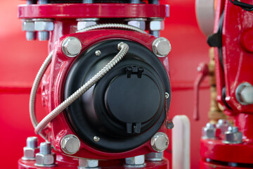 Aufkleber - A red valve with a black cover is shown. The valve is made of metal and has a shiny surface.  part of a fire protection system