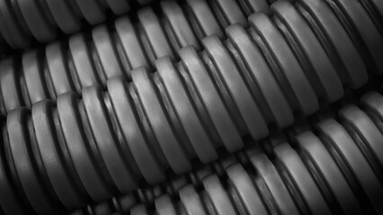 Aufkleber - image is a close up of a bunch of black and grey tubes. The tubes are arranged in a spiral pattern, with some overlapping and others standing alone. Scene is somewhat abstract and somewhat chaotic.