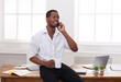 © Prostock-studio - Business call. Young african-american businessman in white has mobile phone talk in modern white office interior.