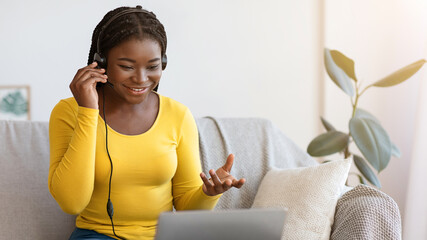 Aufkleber - Video Call. Positive Black Lady Having Web Conference Via Laptop At Home, Smiling African Woman Talking At Camera While Sitting On Couch In Living Room, Enjoying Online Communication, Copy Space