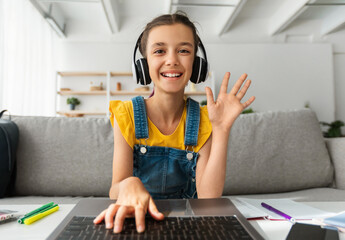Poster - Web-based Education, Remote Communication Concept. Portrait of smiling girl wearing wireless headphones studying at online school, attending distant course using pc waving hand hi, webcam view