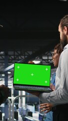 Poster - Vertical video Army tech specialist in data center and coworkers using green screen laptop to troubleshoot military computer systems. Soldier and command center server room admins using chroma key