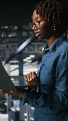 Poster - vertical video data center engineer walking on industrial platform, running diagnostics on equipment