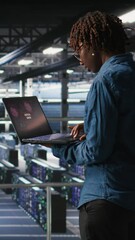 Poster - Vertical video Data center software developer panicking after receiving critical error popup on laptop display. African american woman in server hub alerted by bugs causing low hardware performance