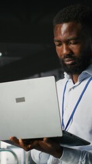 Poster - vertical video technicians on data center industrial platform analyzing performance outputs after co