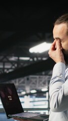 Poster - Vertical video Data center developer frustrated by critical error affecting laptop. Irate server farm worker reacting to hardware performance issues triggered by unresolved software bugs, camera B