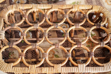 Poster - Close-up displays a handcrafted woven basket, featuring a unique pattern of interlocked circular designs. The textures showcase rustic charm, ideal for home decor, storage, or artistic projects.