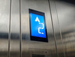© Pernandi Imanuddin - Close-up shot displaying an elevator panel highlighting floor number and direction, creating a sense of modern accessibility and urban convenience in indoor transportation settings.