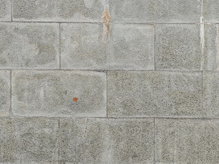 Poster - Close-up on an aged gray wall showcasing textured rectangular blocks. The weathered facade and rough texture of the masonry provides a rustic and versatile backdrop or surface design element.