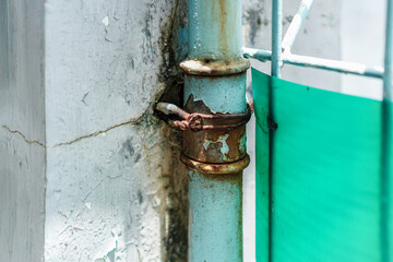 Poster - Close-up of weathered metal displaying paint peeling and rust, creating a rustic, textured surface. The light emphasizes the grunge details and the contrast between the rusty metal and green surface.