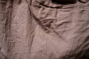 Poster - Detailed close-up of textured cloth with intricate folds, highlighting its raw beauty and earthy tones. Perfect to demonstrate the quality of textile manufacturing and design.