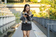 © Art_Photo - Student reading book for exam preparation gaining knowledge, campus life education journey, academic study, young asian woman with backpack learning outdoors scholarly lifestyle, learning success