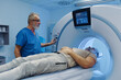 © Halfpoint - Male patient undergoing CT scan examination in hospital.