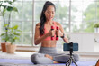 © weedezign - asian trainer woman live streaming online about wellness exercise at home.Influrencer marketing