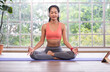 © weedezign - young healthy woman practice yoga mudra on a mat at home, in a yoga sitting position