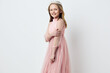 © SHOTPRIME STUDIO - Young girl in a pink tulle dress smiling against a light background, perfect for fashion and children s photography Key themes of joy and elegance highlighted
