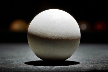 Poster - Close-up of a smooth, round white sphere illuminated against a dark background
