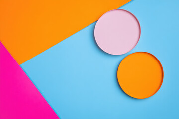 Aufkleber - Colorful geometric background with two round shapes on vibrant blue, orange, and pink surfaces, creating playful and modern design