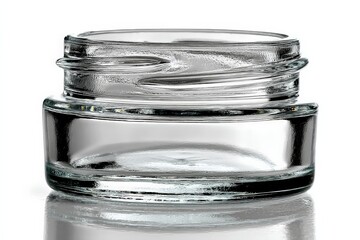 Poster - Clear glass jar with unique swirling design on a reflective surface captured in bright light