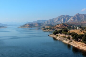 Poster - Beautiful landscape view of calm waters and mountains near a scenic river during a clear day