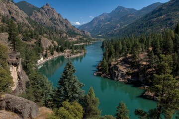 Poster - Mountainous river landscape with vibrant blue waters and lush greenery during a sunny day in the wilderness