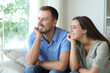 © Antonioguillem - Happy relaxed couple looking through a window at home