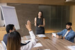 © fizkes - What is your opinion? Friendly female business trainer teacher ask question to motivated multiethnic office employee workshop training event participants encourage audience class to discuss share vote