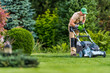 © Tomasz Zajda - Man Mowing Grass in a Lush Garden on a Sunny Day With Vibrant Greenery and Well-Maintained Plants
