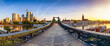 © moofushi - Panoramic view of the old iron bridge Eiserner Steg crossing the Main river in Frankfurt, Germany, with the skyline behind during summer sunrise