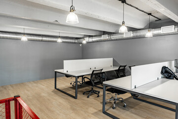 Poster - Modern co-working space with minimalist design and ample natural light in a bustling urban setting