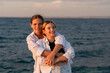© svetograph - Mother Daughter Beach Sunset Hug - Two women, likely a mother and daughter, embrace on a beach at sunset.
