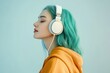 © Igor - Side view of joyful young woman wearing hoodie and listening to music