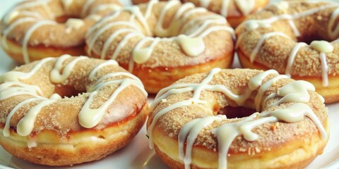 Aufkleber - Close-up of a plate of frosted donuts with a sprinkle of cinnamon sugar, a sweet and indulgent treat