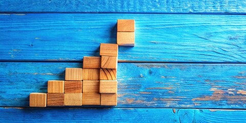 Poster - Wooden blocks arranged in an ascending pattern on a blue wooden background, symbolizing growth and progress