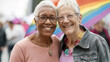 © Arcane Imaginarium - Happy Older Senior Gay Lesbian Women Couple Parade. Happy old senior elder lesbian women couple with rainbow flag at a gay pride parade