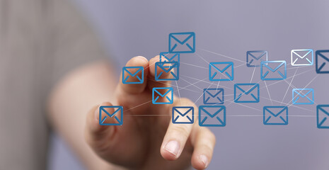 Aufkleber - Hand interacting with a network of email icons, representing global communication and connectivity.