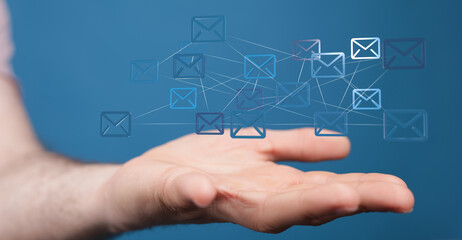 Hand holding network of email icons.  Digital communication, global connectivity.