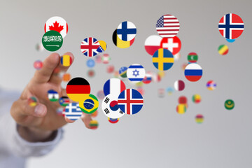 Leinwandbilder - Image of many national flags as colorful circles floating around a hand, representing international connections.