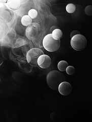 Poster - An abstract black and white image features a collection of translucent, overlapping bubbles of varying sizes. The bubbles are scattered across a dark background, creating a sense of depth and movement
