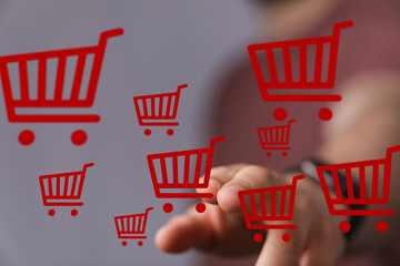 Poster - Person interacts with floating shopping carts, symbolizing online shopping and e-commerce.