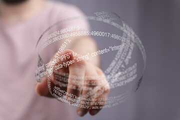 Fototapete - Close-up of a hand interacting with a 3D holographic display of code, showcasing digital technology.