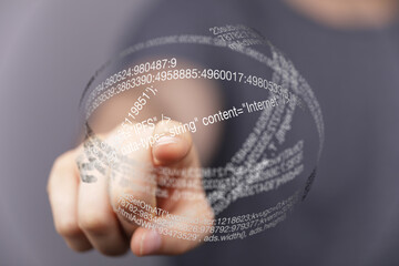 Fototapete - Hand pointing at a futuristic holographic display showing data streams and code.