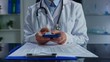 © kinomaster - Doctor Using Smartphone in Medical Office Environment