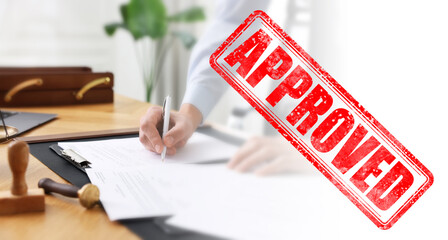 Fototapete - Man signing document at table in office and red stamp Approved, banner design