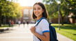 © Melissa - Smiling teenager girl walking to school with backpack on her back