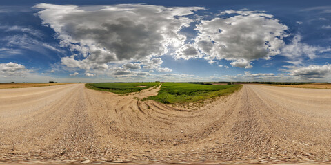 Wall Mural - hdri 360 panorama view on gravel road among fields with clouds in sky in equirectangular full seamle