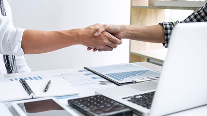 Fototapete - Business casual team shaking hands after a meeting and conference to sign agreement and become partner in the office, results of their successful teamwork, contract between their firms