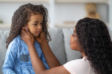 family misunderstanding, childhood problems concept. young black mother comforting her sad offended 